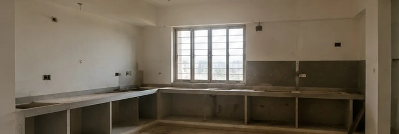 Bare kitchen shell with unfinished concrete counters